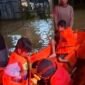 Petugas BPBK Aceh Jaya mengevakuasi warga, termasuk anak-anak, menggunakan perahu karet saat banjir luapan merendam permukiman di Kecamatan Sampoiniet di tengah, Malam Kamis (12/2/2026). Foto: Dok. Istimewa