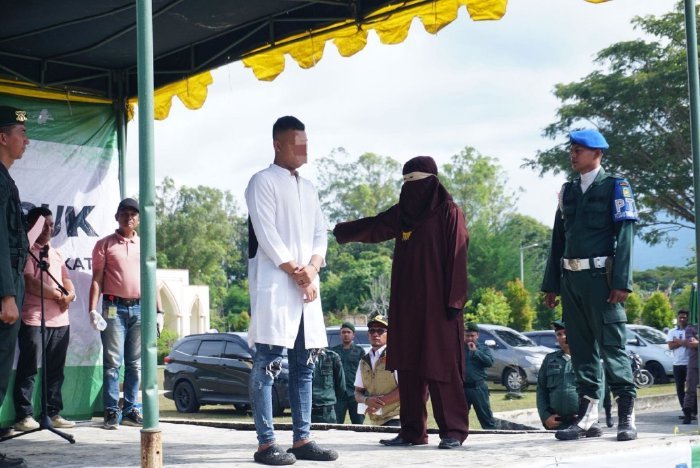 Pelaku pesta Miras/khamar dan pesta seks menjalani hukuman uqubat cambuk, di halaman Masjid Agung Al-Munawwarah, Kota Jantho, Kabupaten Aceh Besar, Kamis (12/2/2026). Foto: Dok. MC Aceh Besar