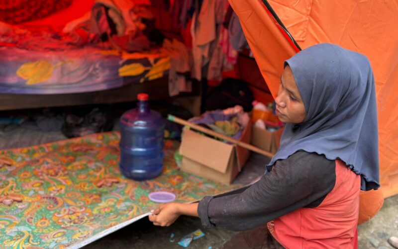 Fitriani membetulkan alas tidur yang digulung akibat hujan saat bertahan di tenda darurat di Desa Teupin Mane, Bireuen, Sabtu (2/5/2026). Foto: Dok. Istimewa 