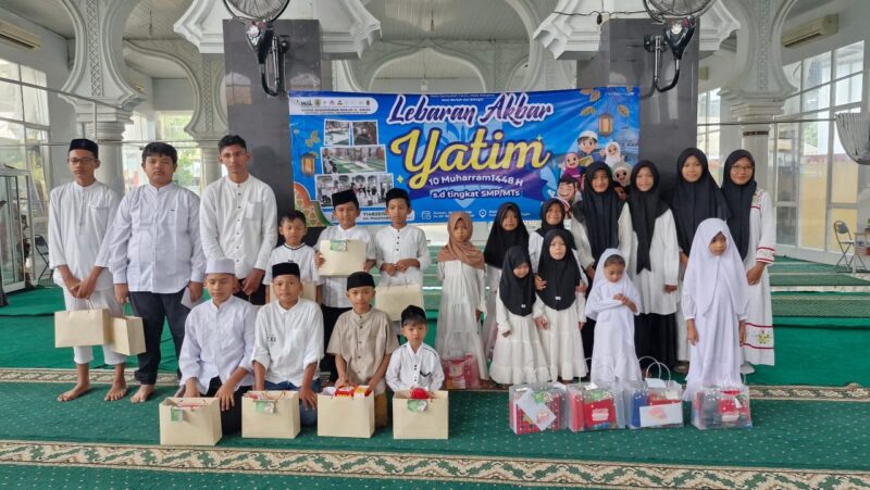 Pemerintah Gampong Lamdingin bersama Badan Kemakmuran Masjid (BKM) Al Abrar dan Baitul Mal Gampong Lamdingin berfoto bersama anak-anak yatim, orang tua, panitia, serta para donatur usai penyerahan santunan dan bingkisan dalam rangka Lebaran Akbar Yatim 1448 Hijriah di Masjid Al Abrar, Banda Aceh, Jumat (27/6/2026). Foto: Dok. Istimewa 