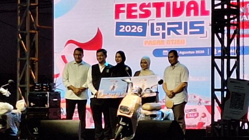 Asisten Perekonomian dan Pembangunan Setda Kota Banda Aceh Faisal menyerahkan hadiah kepada salah satu pemenang kompetisi dalam rangkaian penutupan Festival QRIS Pasar Atjeh di Lapangan Eks Pasar Aceh, Banda Aceh, Senin (17/8/2026). Foto: Dok. Diskominfo Kota Banda Aceh